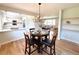 Cozy dining area with a modern chandelier, hardwood floors, and an open kitchen view at 375 Kendall St, Lakewood, CO 80226