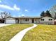 Charming home with walkway leading to double front doors and attached garage at 375 Kendall St, Lakewood, CO 80226