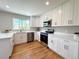 Updated kitchen featuring stainless steel appliances, quartz countertops, and ample cabinet space at 375 Kendall St, Lakewood, CO 80226