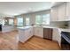 Bright and open kitchen with an island, stainless steel appliances, and hardwood floors at 375 Kendall St, Lakewood, CO 80226