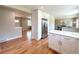 Bright kitchen boasts stainless steel appliances, white cabinetry, and hardwood floors at 375 Kendall St, Lakewood, CO 80226