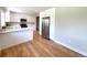 Beautiful kitchen featuring white cabinets, stainless steel refrigerator, and hardwood flooring at 375 Kendall St, Lakewood, CO 80226