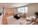 Comfortable living room featuring a large window, hardwood floors, and neutral décor at 375 Kendall St, Lakewood, CO 80226