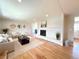 Bright living room featuring hardwood floors, a stone fireplace, and modern furnishings at 375 Kendall St, Lakewood, CO 80226