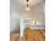 Stylish stairway with white railings, hardwood floors, and a decorative light fixture at 375 Kendall St, Lakewood, CO 80226