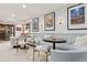 Basement living area has recessed lighting, decorative posters, and a banquette against the wall at 2130 S Milwaukee St, Denver, CO 80210