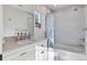 Neutral bathroom features a marble vanity and shower-tub with stylish tile and fixtures at 2130 S Milwaukee St, Denver, CO 80210