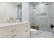 Bathroom featuring a glass-enclosed shower, marble countertop, and neutral tile work at 2130 S Milwaukee St, Denver, CO 80210
