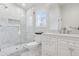 Elegant bathroom features marble shower, glass door, and vanity with great natural light at 2130 S Milwaukee St, Denver, CO 80210