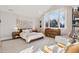 Spacious bedroom featuring a vaulted ceiling, large windows, and a cozy sitting area at 2130 S Milwaukee St, Denver, CO 80210