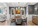 Formal dining room with modern lighting, wainscotting and ample seating for elegant gatherings at 2130 S Milwaukee St, Denver, CO 80210