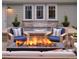 Inviting outdoor space with modern fire pit, comfortable seating, and lush greenery surrounding the patio at 2130 S Milwaukee St, Denver, CO 80210