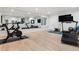 Home gym featuring a treadmill, exercise bike, wall mirror, and hardwood floors at 2130 S Milwaukee St, Denver, CO 80210