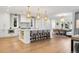Bright, open kitchen featuring a large island, hardwood floors, and modern lighting fixtures at 2130 S Milwaukee St, Denver, CO 80210