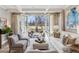 Elegant living room with abundant natural light, comfortable seating, and views of the outdoor space at 2130 S Milwaukee St, Denver, CO 80210