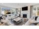 Comfortable living room with a fireplace, large windows, and neutral-toned furniture at 2130 S Milwaukee St, Denver, CO 80210