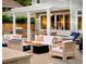 Outdoor living space with a stone patio, built-in kitchen, pergola, and comfortable seating around a fire pit at 2130 S Milwaukee St, Denver, CO 80210