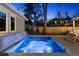 Backyard pool featuring a waterfall, perimeter lighting, and a modern aesthetic at 2130 S Milwaukee St, Denver, CO 80210