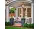 Inviting porch with comfortable seating, stylish lighting, and view of the well-manicured lawn at 2130 S Milwaukee St, Denver, CO 80210