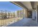 Private balcony with railing and views of the building and neighborhood at 955 Eudora St # 407E, Denver, CO 80220