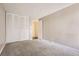 Neutral bedroom featuring a closet with louvered doors and neutral carpet at 955 Eudora St # 407E, Denver, CO 80220