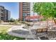 Beautiful courtyard with seating and landscaping, nestled near a towering residential building at 955 Eudora St # 407E, Denver, CO 80220