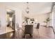 Dining room with hardwood floors, a round glass table with decor, and an attractive chandelier at 955 Eudora St # 407E, Denver, CO 80220