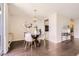 Dining room with hardwood floors, a modern chandelier, and a round glass table at 955 Eudora St # 407E, Denver, CO 80220