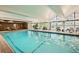 Bright indoor swimming pool with lounge chairs and large windows showcasing the outdoor scenery at 955 Eudora St # 407E, Denver, CO 80220