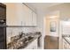 Efficient kitchen features granite countertops, white cabinets, and stainless steel appliances at 955 Eudora St # 407E, Denver, CO 80220