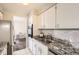 Efficient kitchen features granite countertops, white cabinets, and stainless steel appliances at 955 Eudora St # 407E, Denver, CO 80220