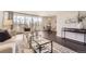 Bright living room with hardwood floors, a stylish rug, and floor to ceiling windows with balcony access at 955 Eudora St # 407E, Denver, CO 80220