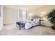Another view of the main bedroom, with a large bed, lamps, and a tree at 955 Eudora St # 407E, Denver, CO 80220
