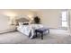Comfortable bedroom with plush carpet, a decorative bench, and lots of space at 955 Eudora St # 407E, Denver, CO 80220