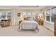 Comfortable bedroom with tray ceilings features carpet and a sitting area with lots of natural light at 1033 Petras St, Erie, CO 80516