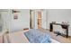 Cozy bedroom with a light blue blanket, a desk, and doorway views to stairway at 1033 Petras St, Erie, CO 80516