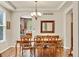 Bright dining room adjacent to kitchen with a stylish chandelier and large windows at 1033 Petras St, Erie, CO 80516