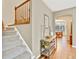 Bright entryway with hardwood floors and staircase leading to dining room at 1033 Petras St, Erie, CO 80516