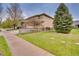 Exterior side view of home featuring a well-maintained lawn and wood fence at 1033 Petras St, Erie, CO 80516
