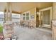 Inviting front porch with stone pillars, seating, and a decorative entrance door at 1033 Petras St, Erie, CO 80516