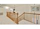 Upstairs hallway featuring wooden railing and natural light at 1033 Petras St, Erie, CO 80516