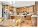 Well-lit kitchen with wooden cabinets, stainless steel appliances, and center island at 1033 Petras St, Erie, CO 80516
