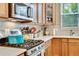 Close-up of kitchen with stainless steel oven and gas cooktop, complemented by light countertops at 1033 Petras St, Erie, CO 80516