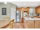 Bright kitchen featuring wooden cabinets, stainless steel refrigerator, and ample counter space at 1033 Petras St, Erie, CO 80516