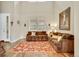 Cozy living room with hardwood floors, comfortable seating, and bright natural light at 1033 Petras St, Erie, CO 80516