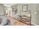 Inviting living room with stylish console table, warm hardwood floors, and access to the upper level at 1033 Petras St, Erie, CO 80516