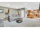 Inviting living room with a gray sofa, round coffee table, and adjacent kitchen at 1033 Petras St, Erie, CO 80516