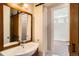 Bathroom featuring sliding barn door, marble floors, and sink at 1533 S Columbine St, Denver, CO 80210