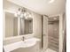 Bright bathroom featuring a vanity with integrated sink, modern lighting, and a shower with white subway tile at 1533 S Columbine St, Denver, CO 80210