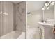 Modern bathroom with sleek vanity, white flooring, and a separate shower and tub with beautiful white tile at 1533 S Columbine St, Denver, CO 80210